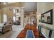 Elegant foyer featuring hardwood floors, high ceilings, and an open view of the staircase and living area at 15258 W 75Th Pl, Arvada, CO 80007