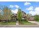 Charming home showcasing a beautifully landscaped front yard, inviting porch, and attached garage at 15258 W 75Th Pl, Arvada, CO 80007