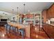 Open kitchen featuring an island with seating, stainless steel appliances, and seamless transition to other living areas at 15258 W 75Th Pl, Arvada, CO 80007