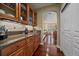 Stylish kitchen featuring wood cabinets, granite countertops, and open access to other rooms at 15258 W 75Th Pl, Arvada, CO 80007