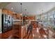Well-lit kitchen with a large island, stainless steel appliances, and a cozy breakfast nook by the window at 15258 W 75Th Pl, Arvada, CO 80007
