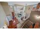 Open concept living space with hardwood floors, a dining area, and an inviting entryway at 15258 W 75Th Pl, Arvada, CO 80007