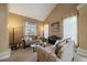 Cozy living room with comfortable seating, a vaulted ceiling, large windows, and natural light at 15258 W 75Th Pl, Arvada, CO 80007