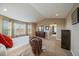 Bright main bedroom featuring neutral tones, large windows, and comfortable carpet at 15258 W 75Th Pl, Arvada, CO 80007