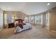 Spacious main bedroom with large windows, plush carpet, and a cozy, inviting feel at 15258 W 75Th Pl, Arvada, CO 80007