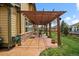 Covered patio with pergola, offering a relaxing outdoor space with seating and green surroundings at 15258 W 75Th Pl, Arvada, CO 80007