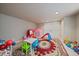 Bright playroom featuring neutral walls, vibrant decor, carpet, and a closet at 15258 W 75Th Pl, Arvada, CO 80007