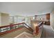 View of the staircase and loft featuring beautiful railings, open space, and natural light at 15258 W 75Th Pl, Arvada, CO 80007