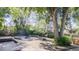 Backyard featuring a fire pit, swing, mature trees and greenery at 2260 Lilly Dr, Thornton, CO 80229