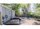 Backyard featuring deck, fire pit, stone patio and mature trees at 2260 Lilly Dr, Thornton, CO 80229