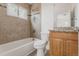 Bathroom featuring tub-shower combination and vanity with granite counter at 2260 Lilly Dr, Thornton, CO 80229