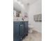 Updated bathroom features a blue vanity, grey tile floors and a shower/tub combo at 2260 Lilly Dr, Thornton, CO 80229