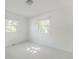 Bright bedroom featuring two windows, neutral carpet and light-colored walls at 2260 Lilly Dr, Thornton, CO 80229
