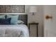 Bedroom with queen bed, side table, lamp and modern art at 2260 Lilly Dr, Thornton, CO 80229