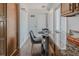 Cozy dining area with a glass table set next to the kitchen, flooded with natural light from a nearby window at 2260 Lilly Dr, Thornton, CO 80229