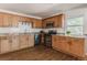 The kitchen features wood cabinetry, granite countertops, stainless steel appliances, and a subway tile backsplash at 2260 Lilly Dr, Thornton, CO 80229