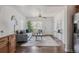 Bright living room with stylish furniture, a ceiling fan and a large window overlooking the front yard at 2260 Lilly Dr, Thornton, CO 80229