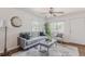Cozy living room with gray sofa, ceiling fan, decorative rug and modern art at 2260 Lilly Dr, Thornton, CO 80229