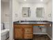 Bathroom with double sinks, granite countertop, and tiled floor at 7250 Eastmoor Dr # 105, Denver, CO 80237