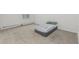 Neutral bedroom featuring plush carpeting, baseboard heating, and natural light from the large window at 7250 Eastmoor Dr # 105, Denver, CO 80237