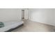 An open bedroom showing neutral walls, carpet and an open closet door at 7250 Eastmoor Dr # 105, Denver, CO 80237