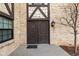 Double front door with a brick facade, a storm door, and outdoor lighting at 7250 Eastmoor Dr # 105, Denver, CO 80237