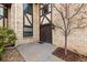 Entrance to the house, featuring a double door, a brown door, and a brick facade at 7250 Eastmoor Dr # 105, Denver, CO 80237