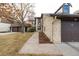 Street view of home with a garage, lush lawn, and gorgeous fall trees at 7250 Eastmoor Dr # 105, Denver, CO 80237