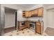 Kitchen with stainless steel appliances, granite countertops, and hardwood cabinets at 7250 Eastmoor Dr # 105, Denver, CO 80237