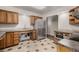 Kitchen with stainless steel appliances, stone countertops, and tile flooring at 7250 Eastmoor Dr # 105, Denver, CO 80237