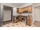 Bright kitchen featuring stainless steel appliances, granite counters, and stylish tile flooring at 7250 Eastmoor Dr # 105, Denver, CO 80237