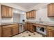 Well-lit kitchen features stainless steel appliances and ample counter space with wood cabinets at 7250 Eastmoor Dr # 105, Denver, CO 80237