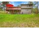 Picturesque backyard featuring a spacious deck with seating, and a lush green lawn at 28065 Camel Heights Cir, Evergreen, CO 80439