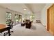 Finished basement with large windows, a leather sofa, and door to the exterior at 28065 Camel Heights Cir, Evergreen, CO 80439