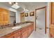 Bathroom featuring double sinks, a walk-in closet, and tile flooring at 28065 Camel Heights Cir, Evergreen, CO 80439