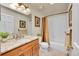 Bathroom featuring a vanity with granite countertop and shower-tub combo at 28065 Camel Heights Cir, Evergreen, CO 80439