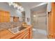 Well-lit bathroom featuring a modern vanity, stylish sink, and a glass-enclosed shower at 28065 Camel Heights Cir, Evergreen, CO 80439