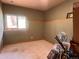Cozy bedroom featuring a window, carpeted floor, and neutral walls, ideal for rest at 28065 Camel Heights Cir, Evergreen, CO 80439