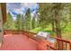 Large outdoor deck with stainless steel grill and wooded views at 28065 Camel Heights Cir, Evergreen, CO 80439