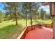 Large outdoor deck with wooded backyard views at 28065 Camel Heights Cir, Evergreen, CO 80439
