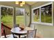 Sunlit dining area with wooded views from multiple windows, and wooden cabinets at 28065 Camel Heights Cir, Evergreen, CO 80439