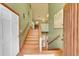 Bright foyer featuring a staircase with wooden railings, elegant light fixtures, and a stylish art piece at 28065 Camel Heights Cir, Evergreen, CO 80439