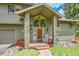Charming front entrance with a wooden door, rocking chair, and beautifully landscaped surroundings at 28065 Camel Heights Cir, Evergreen, CO 80439