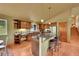 Bright kitchen features wooden cabinets, granite counters, stainless appliances, and a large central island at 28065 Camel Heights Cir, Evergreen, CO 80439