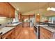 A view of the kitchen boasting wooden cabinets, granite counters, stainless appliances, and hardwood floors at 28065 Camel Heights Cir, Evergreen, CO 80439