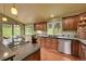 A view of the kitchen featuring wooden cabinets, granite counters, stainless appliances, and a breakfast nook at 28065 Camel Heights Cir, Evergreen, CO 80439