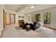 Spacious living room with plush carpeting, natural light, and serene backyard views at 28065 Camel Heights Cir, Evergreen, CO 80439