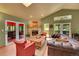 Comfortable living room showcasing a stone fireplace, cozy seating, and access to the outdoor deck at 28065 Camel Heights Cir, Evergreen, CO 80439