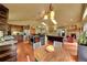 Open concept kitchen and living area boasting hardwood floors, fireplace, and ample natural light at 28065 Camel Heights Cir, Evergreen, CO 80439