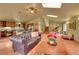 Open concept living room featuring a fireplace, kitchen with bar seating, piano and comfortable furniture at 28065 Camel Heights Cir, Evergreen, CO 80439